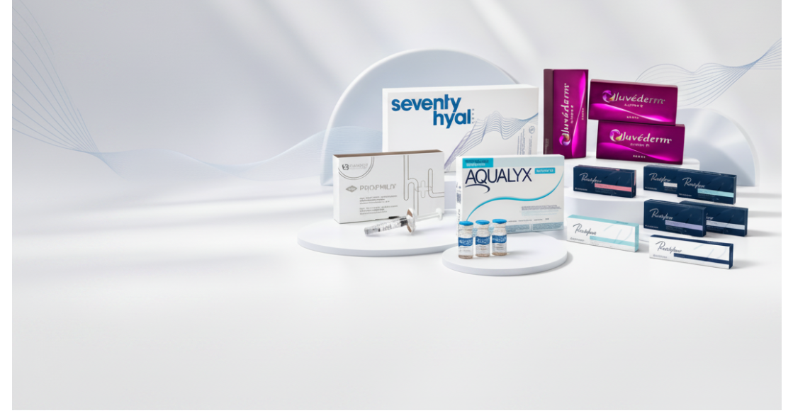 A collection of cosmetic and skincare product boxes and vials arranged on white display risers. Visible brands include Seventy Hyal, Aqualyx, Juvéderm, and Profhilo.